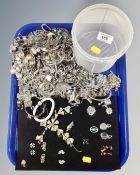 A tray containing a large quantity of silver-tone costume jewellery.