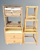 A nest of three bamboo and wicker tables together with a pine two drawer bedside table and a