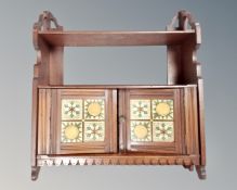 A 19th century double door wall cabinet with shelf and tiled panel doors.