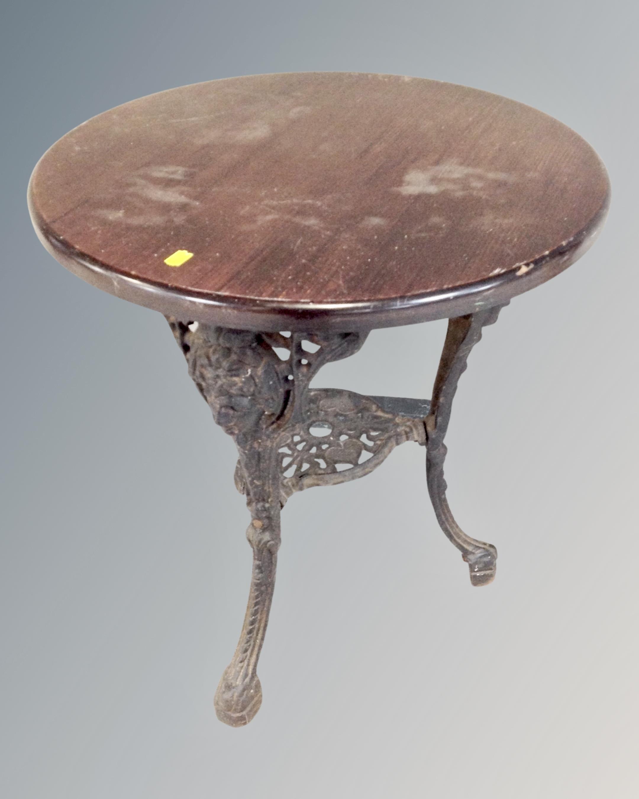 A vintage circular cast iron base pub table.