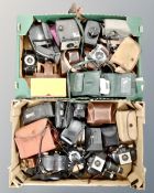 Two boxes containing vintage cameras, Hitachi video camera, camera cases.