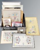 A box containing assorted framed mirrors, needlework panels, prints, ornate cherub mirror.