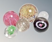 Assorted glass paperweights, glass golf ball, glass globe, Kosta glass,