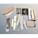 A collection of assorted pocket lighters and penknives to include mother of pearl silver fruit
