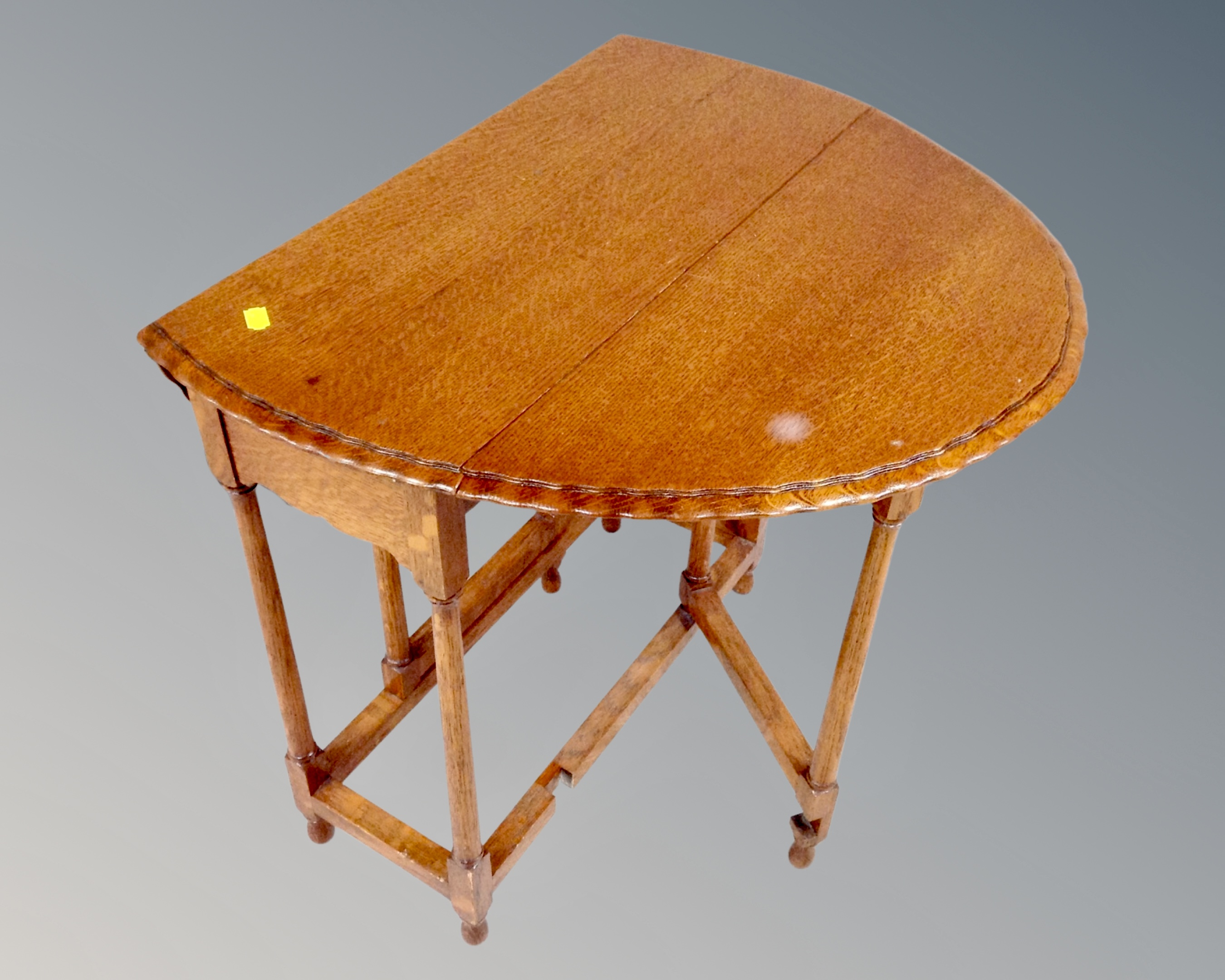 An Edwardian oak gateleg occasional table.