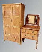An Edwardian oak double door gentleman's wardrobe fitted with a drawer,