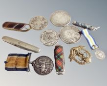 A box containing Chinese coins, pocket knives, military badges,