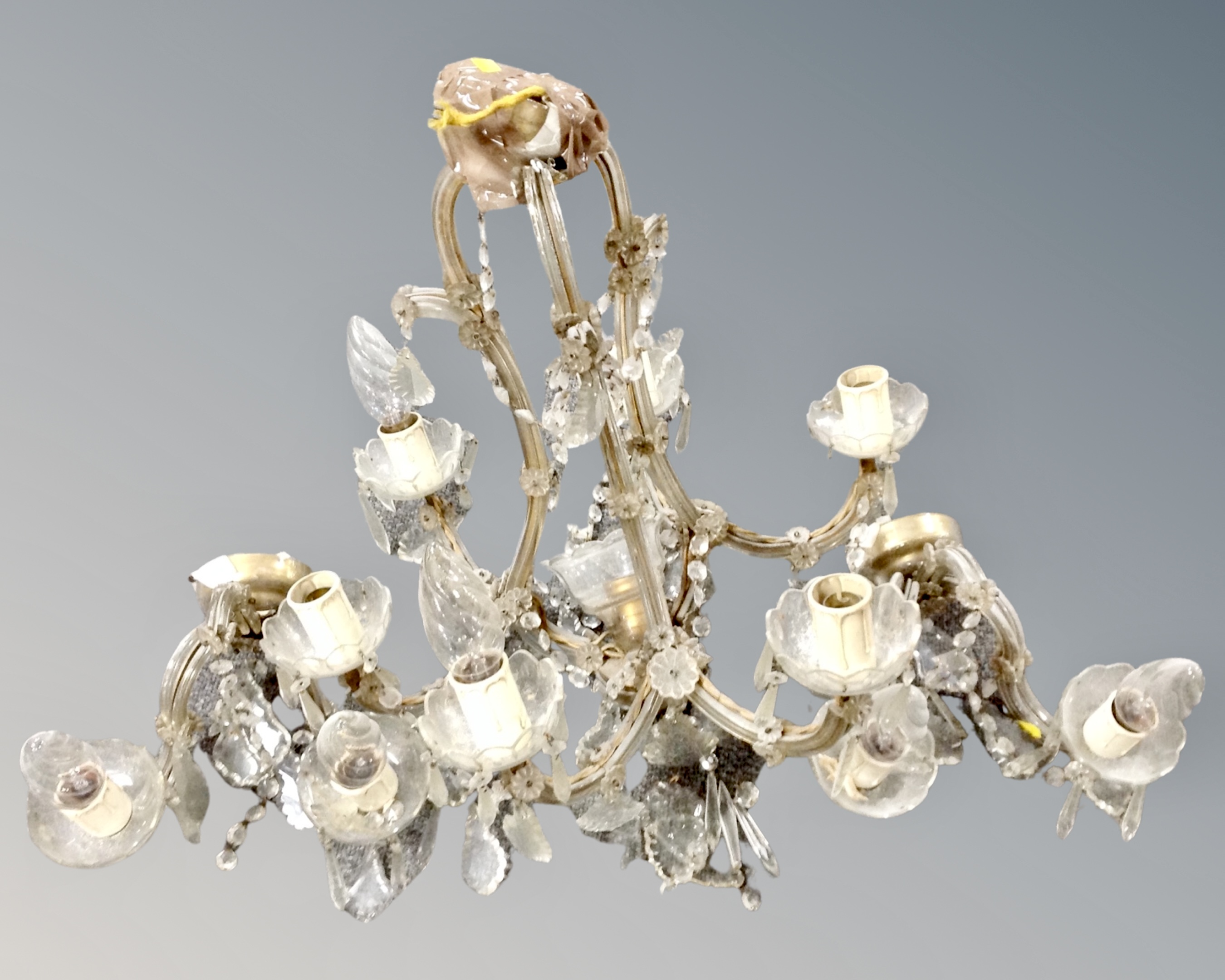 A vintage glass six-way light fitting with drops together with matching wall lights