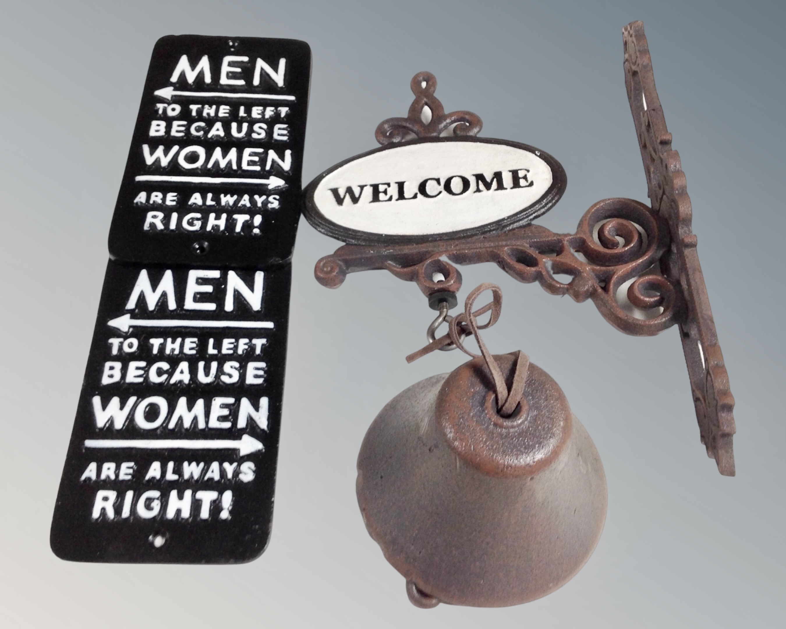 A cast iron Welcome bell on wall bracket, together with two further cast iron signs.