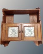 A 19th century oak double door wall cabinet with shelf and tiled panel doors.