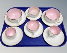 A tray of three pairs of vintage china two-tone teacups and saucers