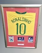 A Ronaldinho signed football shirt in frame with photographic montage, certificate verso.