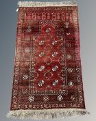 An Afghan prayer rug, 81cm by 130cm.