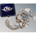 A boxed silver and pearl brooch, Swarovski metal chain and hoop pendant, a similar set,