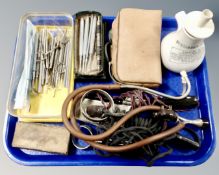 A tray containing a quantity of assorted medical instruments, Dr. Nelson's Inhaler.