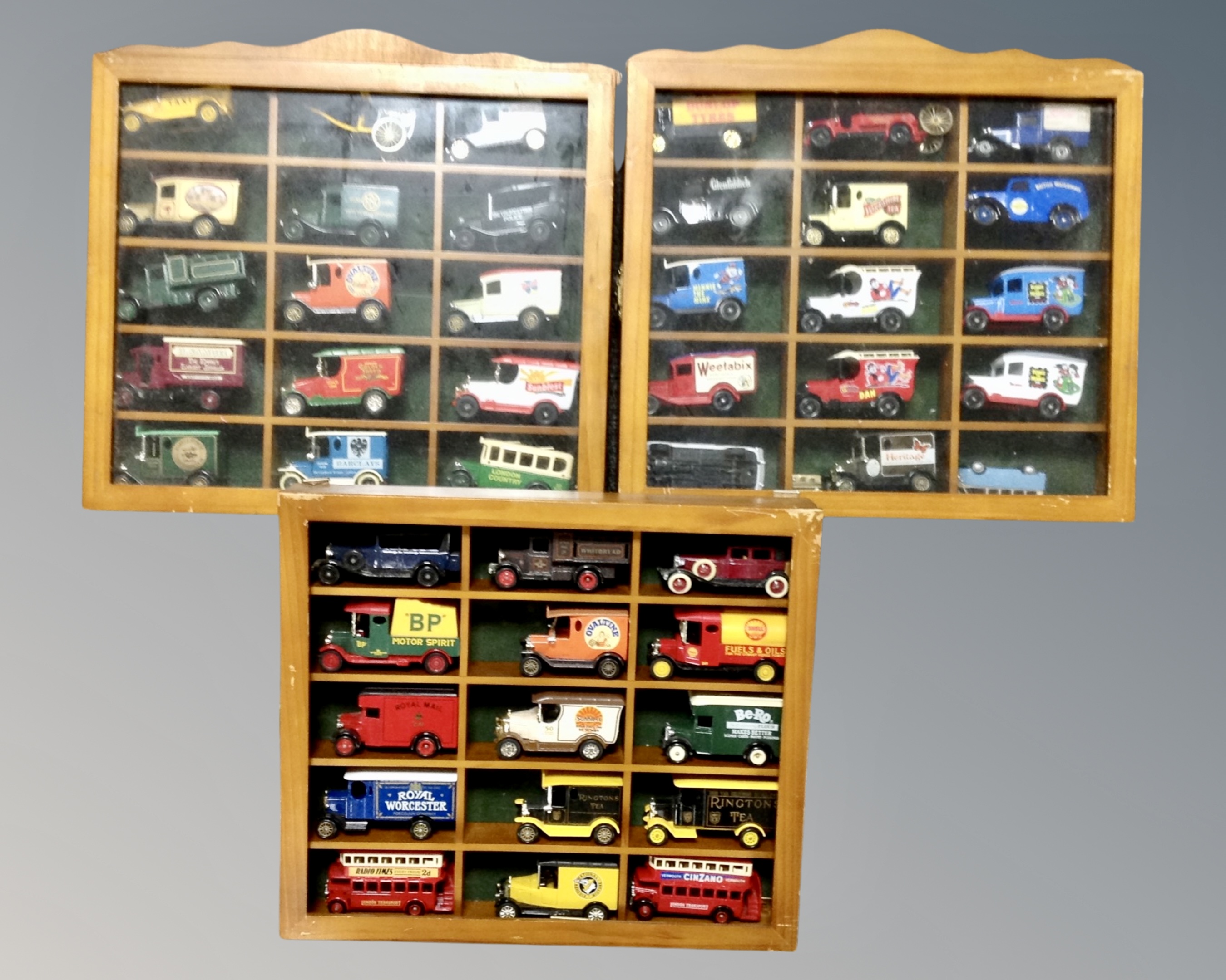 Three pine framed display cases containing die cast cars to include Days Gone, Ringtons,