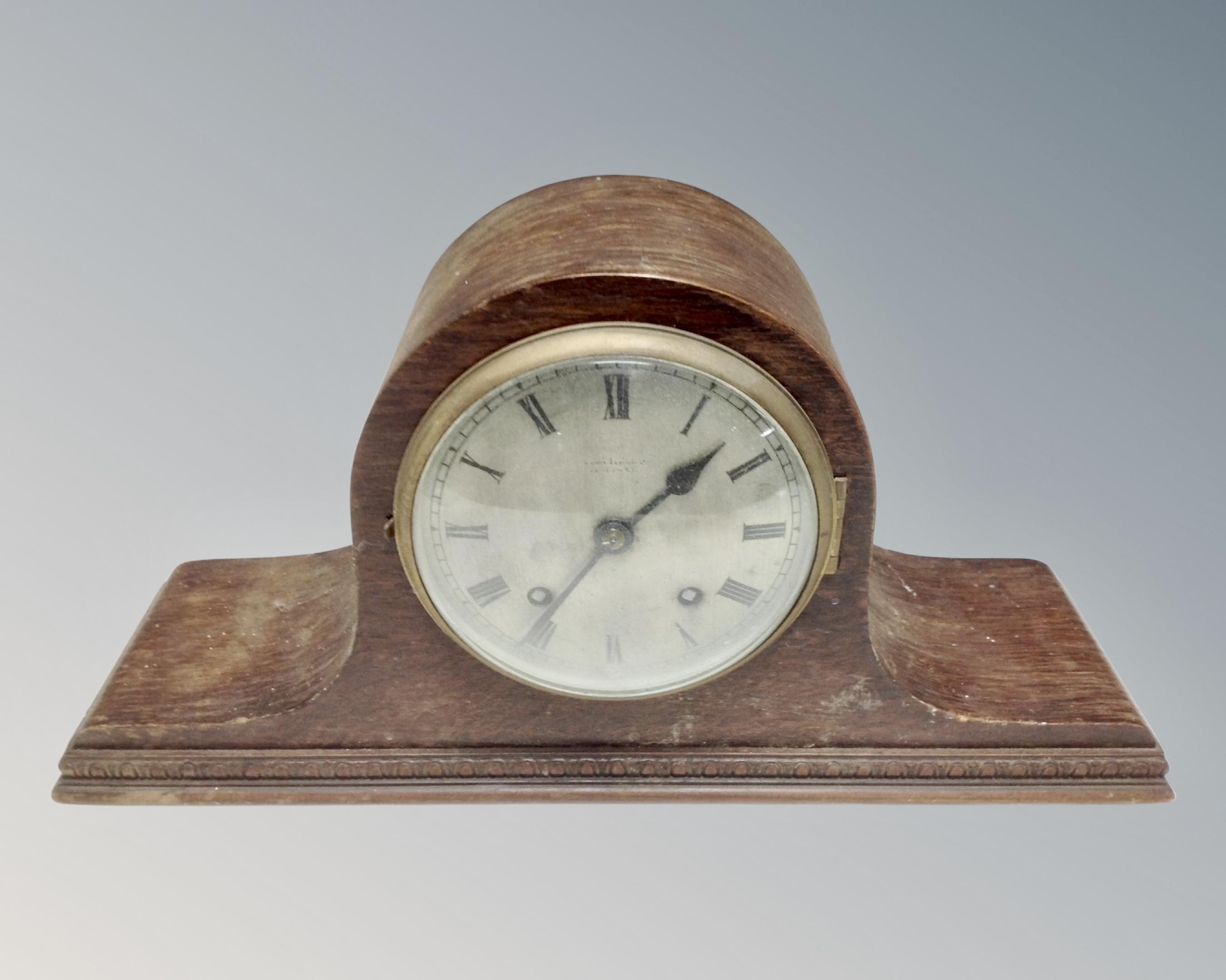 A 1930s eight-day mantel clock with silvered dial.