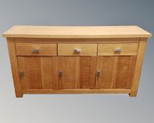 A contemporary triple door sideboard fitted with three drawers above,