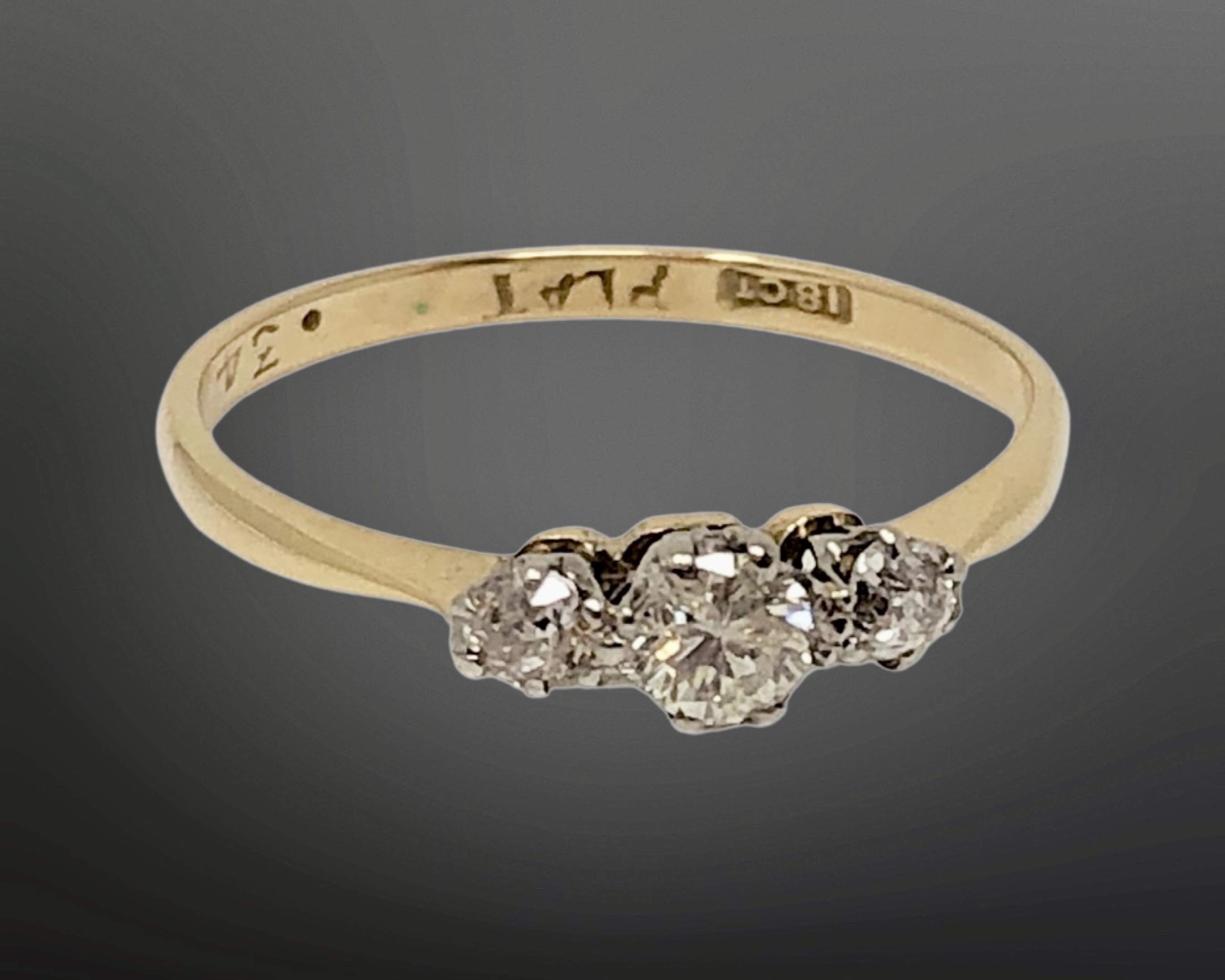 An 18ct gold three stone diamond ring, size O CONDITION REPORT: 1.