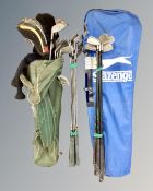 Two golf bags containing assorted clubs including King Cobra and Ben Hogan irons and drivers.