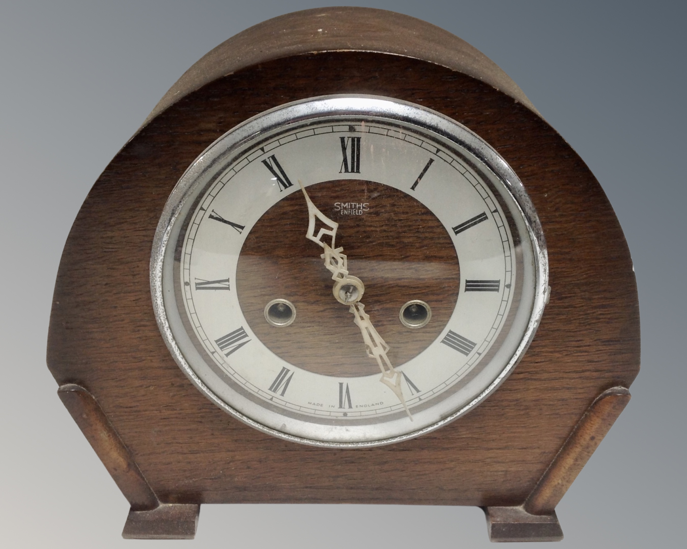 A 1930s oak cased Smiths Enfield eight-day mantel clock.