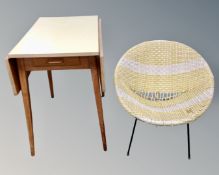 A mid-20th century Scandinavian melamine topped flap sided kitchen table together with a rattan