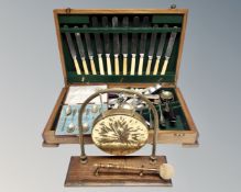 An Edwardian oak canteen containing cutlery, further cased set of six plated tea spoons,