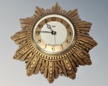 A Smiths gilt sunburst electric wall clock.