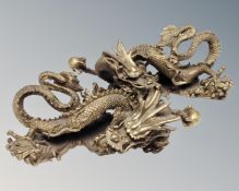 A pair of decorative brass dragon figures
