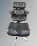 A Charles Eames style Model 670 & 671 black leather upholstered swivel armchair with matching stool.