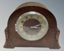 A 1930s oak cased eight-day mantel clock.