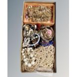 A tray of costume jewellery together with small tray of pearls, bangles,