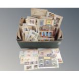 A box of hundreds of assorted world stamps mounted on card