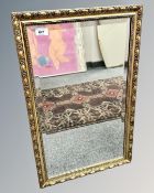 A bevelled mirror in gilt frame, 43cm by 68cm.