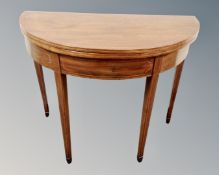 A Victorian inlaid mahogany D-shaped turnover top table.