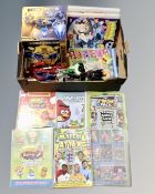A box containing action figures including Spider-Man, Batman, Transformers Bee Vision helmet,