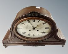 A large oak cased eight day mantel clock with silvered dial,