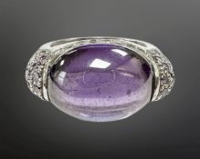 A silver cabochon amethyst dress ring, size K.