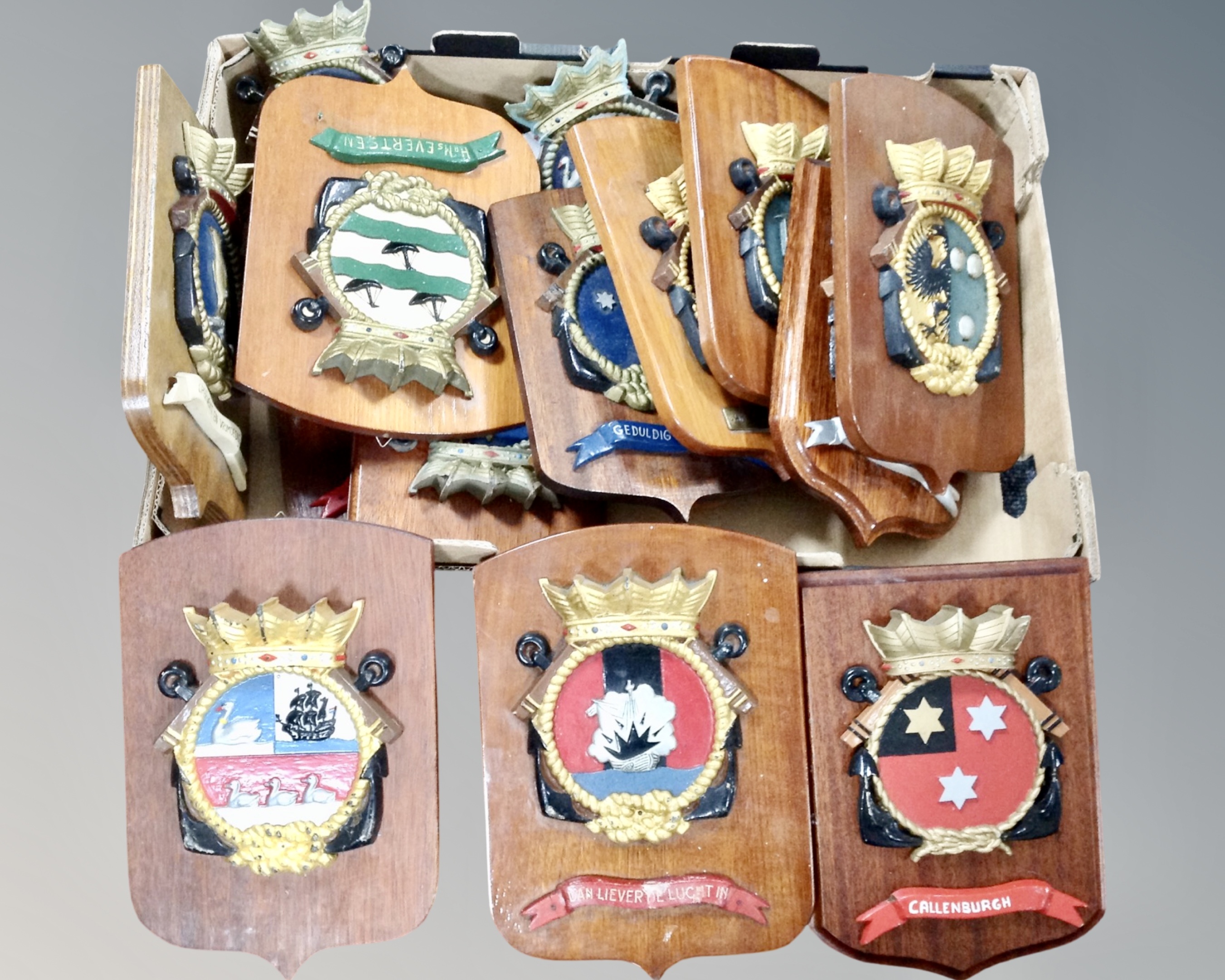 A box containing a quantity of nautical plaques on boards