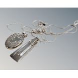 A silver photo locket on silver chain,