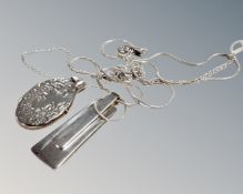 A silver photo locket on silver chain,