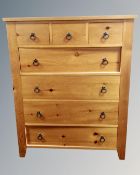 A contemporary pine three-over-four chest of drawers.