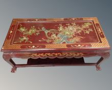 A contemporary Japanese style lacqured two tier coffee table on claw feet.