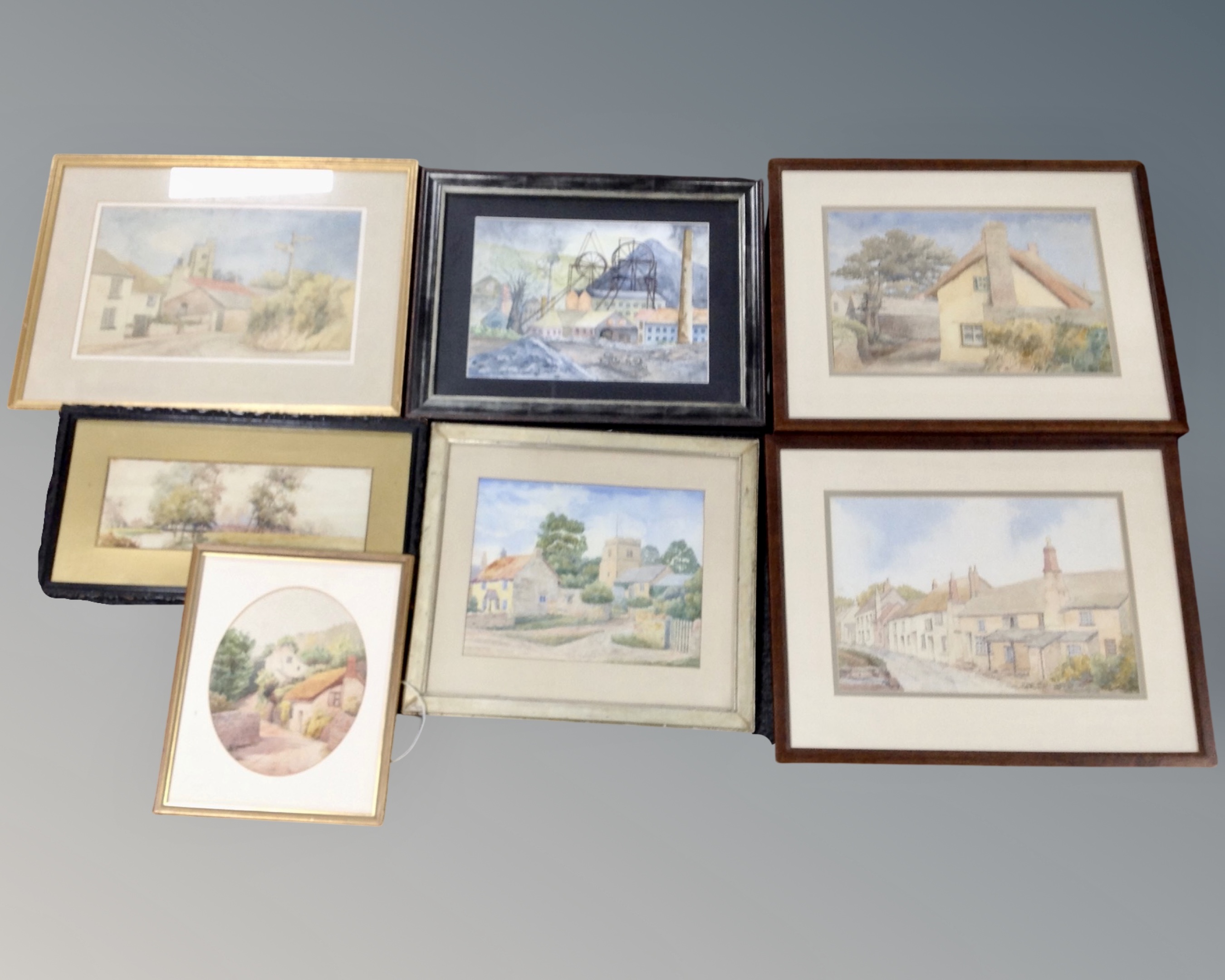 A box containing seven assorted antique and later watercolours including a study of a river through