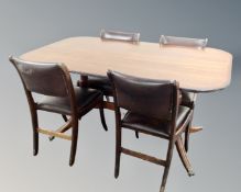 A Regency style pedestal tilt topped dining table on brass capped feet together with a set of four