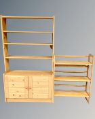 A set of pine open bookshelves fitted with a double door cupboard below and a further set of pine