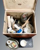 A vintage leather travel case containing glass ware, ceramics, antlers,