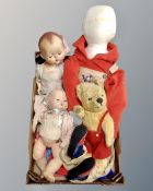 A box containing mid-20th century dolls, an English Mohair teddy bear and a soft toy dummy.
