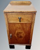 A 1930s oak bedside cabinet fitted with a drawer.