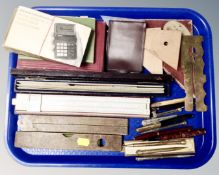 A tray containing folding boxwood rulers, spirit level, calculating ruler, drawing instruments,